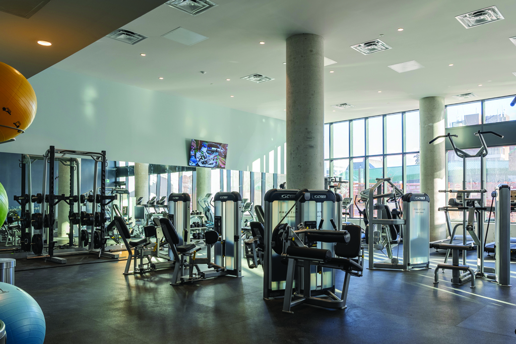 Fitness Room with gym equipment in a beautiful bright and large room